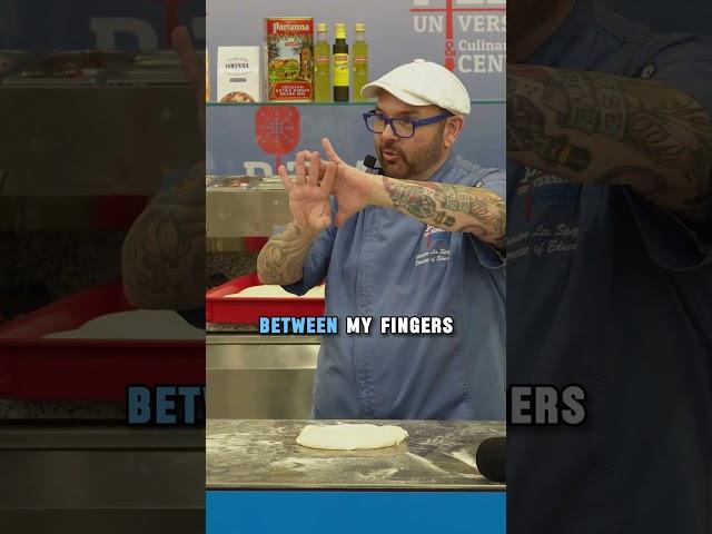 Stretching pizza dough like and Italian
