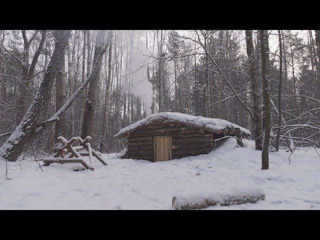 hiding in a huge dugout during a snow storm, spending the night in  bushcraft shelter