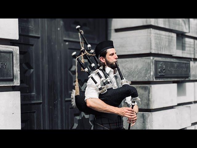 A man plays a bagpipe in Edinburgh Scotland