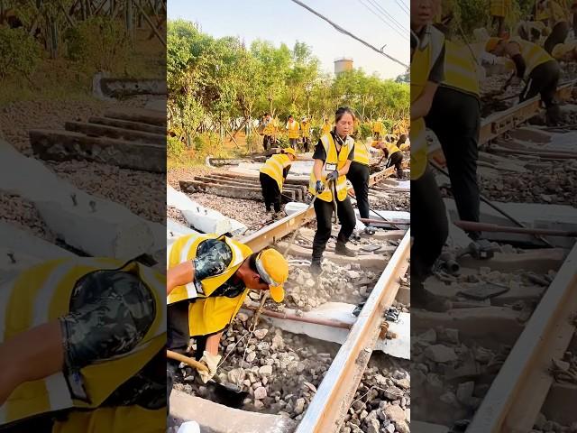 Railway workers maintaining the tracks—a physically demanding job.