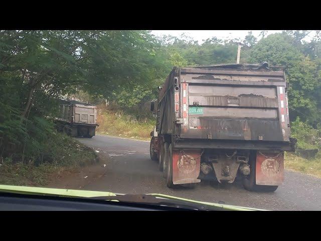 Loaded trucks climbing steep & narrow hill in the countryside mountain ️