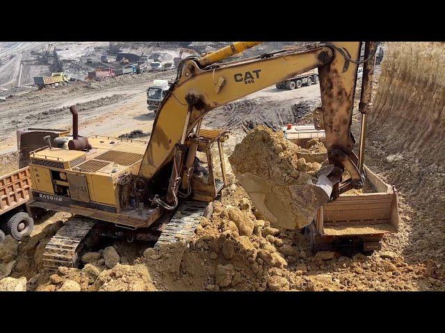 Old Hero in Action: Caterpillar 245B Excavator with Over 120,000 Working Hours Loading Overburden