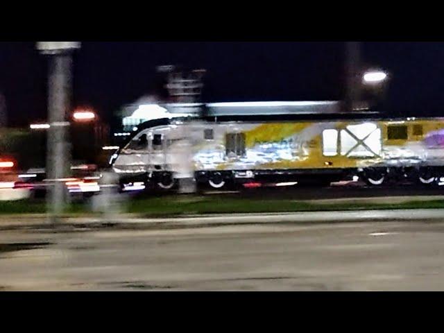 BrightLine train, high speed rail in Florida, USA. At speed across a road crossing.