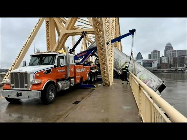 Tow truck crew says years of experience helped them pull dangling semi back onto 2nd Street Bridge