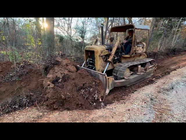 70 year old bulldozer working hard along with new equipment to improve the driveway drainage