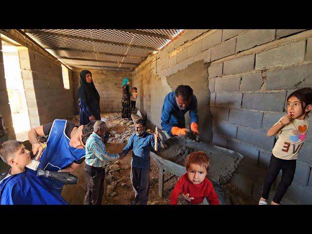 While the children cut their hair for school, Shirvan helps the workers build the house