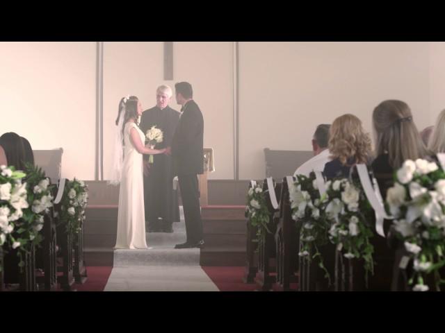 Bride and groom walking up the aisle to a preacher.