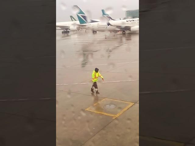 Aircraft marshal dancing. Toronto Pearson airport.