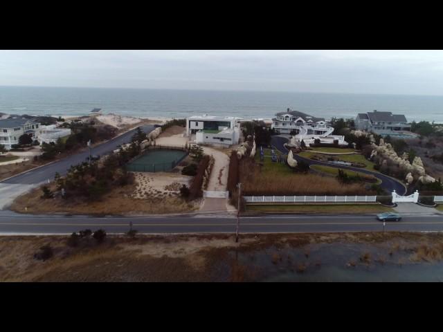 Aerial approach across bay to oceanfront houses, Hamptons