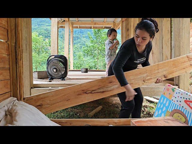 A single mother and her daughter built a wooden house wall