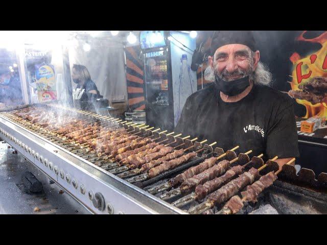 Italy Street Food Fair. Small Sticks of Sheep Meat Roasted on Charcoal. "Arrosticini"