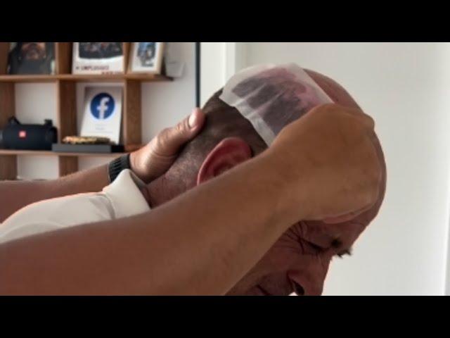 Waxing his head bald