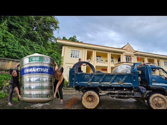 Female driver of a ben truck Bring the water tank to the village for the farmers.