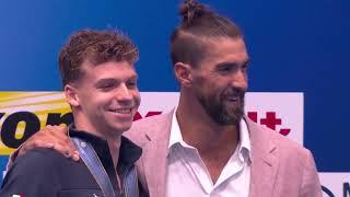 American swimming legend Michael Phelps presents gold as Leon Marchand breaks his world record