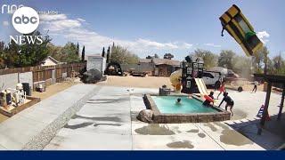 Dust devil caught on camera carrying away bouncy house