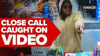Video: Store clerk dodges gunshot during close call with gunman