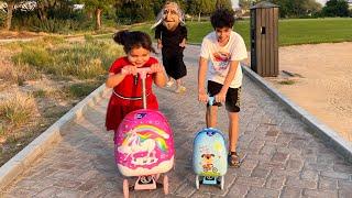 Children play on scooters in the park