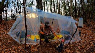 Wild camping while listening to the sound of the dawn rain in a perfect vinyl shelter.