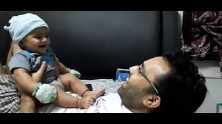 Very cute Indian baby laughing with his dad .