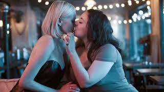 Girl on Girl Kiss: Tender Moment in a Cozy Café Scene