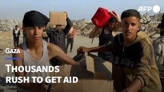 Thousands rush into new aid distribution centre in south Gaza | AFP