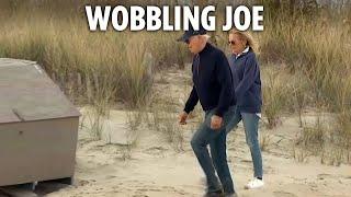 Moment Joe Biden stumbles on sandy beach as Jill struggles to keep him up during day out in Delaware