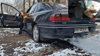 Nastya revving smoky Opel and produces exhaust fumes