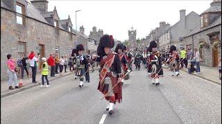 Chieftain leads the massed Pipes and Drums on the march to 2024 Dufftown Highland Games in Scotland