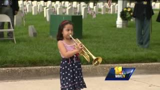 Girl plays Taps in tribute to fallen service members