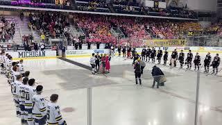 Wife of Michigan hockey coach drops ceremonial first puck after cancer diagnosis