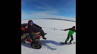 Snowboarding behind the Can Am Maverick X3 on a frozen lake in Canada