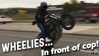 BIKER WHEELIES IN FRONT OF COP