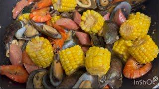 Seafood mix with hotdogs and corn