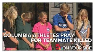 Columbia High School athletes and coaches pray together after teen is killed in crash, three other s