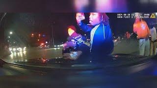 DASHCAM | Street takeover in Cleveland shows people jumping on police officer's hood of car