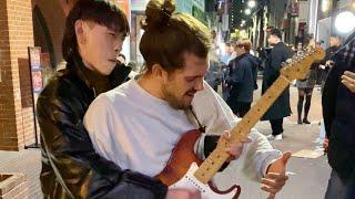 Street performer surprised by guitarist passing by in Korea