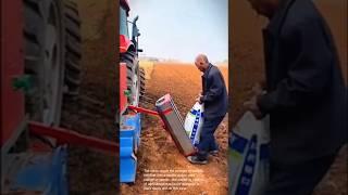 Planting season: loading fertilizer into a seeder