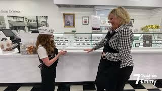 Emmy is asking 7 Questions and packing a box of chocolates at See’s Candies