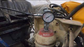 Charging the accumulator bottle on a Putzmeister concrete pump.