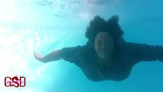 swimming underwater fully clothed