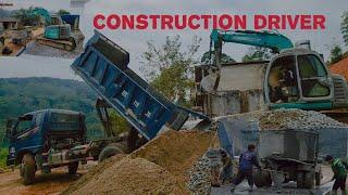 Excavators and concrete trucks work together to create concrete roads in mountainous areas.