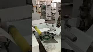 Napkin tissue folding machine with glue lamination and color units