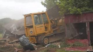 Bulldozer destroys building