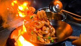 Chinese Street Food -Stir-fried prawns with chili, fried noodles with egg, wontons in red soup