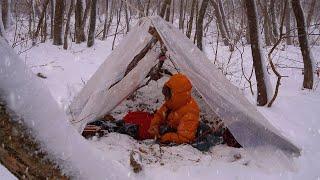 Wild camping in a vinyl shelter deep in the mountains with heavy snowfall.