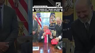 US President Donald Trump hands out “Trump Was Right About Everything” hats to Press reporters