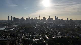 Smoky Wednesday morning drone flight video over Glebe Sydney Australia CBD bridge tower sunny smokey