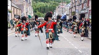 Massed Pipes & Drums parade through Deeside town to start the Ballater Highland Games 2018