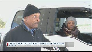 People brave icy roads for essentials