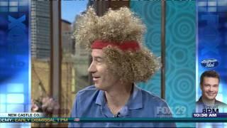 John McEnroe puts on John McEnroe wig